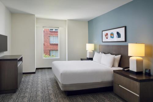 a hotel room with a bed and a television at Hyatt House Atlanta Downtown in Atlanta