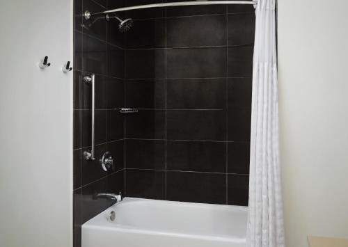 a bathroom with a white tub and a shower at Hyatt House Atlanta Downtown in Atlanta