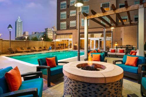 an outdoor patio with a fire pit and a pool at Hyatt House Atlanta Downtown in Atlanta