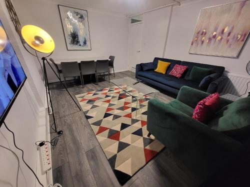 a living room with a couch and a table at London Central Modern Apartment Charlton in London