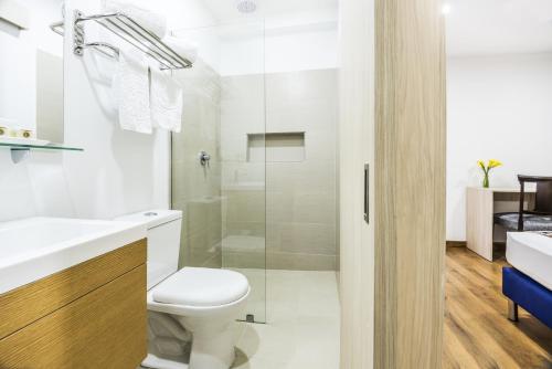 a bathroom with a toilet and a shower at Hotel Asturias Medellin in Medellín