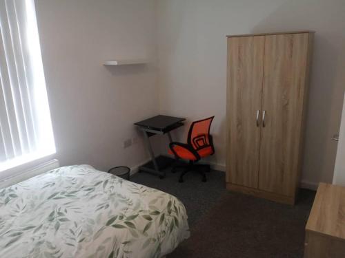 a bedroom with a bed and a desk and a chair at Ensuite Double-bed H3 close to Burnley city centre in Burnley
