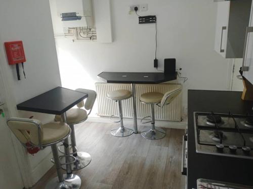 a kitchen with a counter and stools in a room at Ensuite Double-bed H3 close to Burnley city centre in Burnley