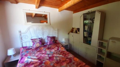 sypialnia z białym łóżkiem i kolorowym kocem w obiekcie Réved(ez) w mieście Szigetmonostor
