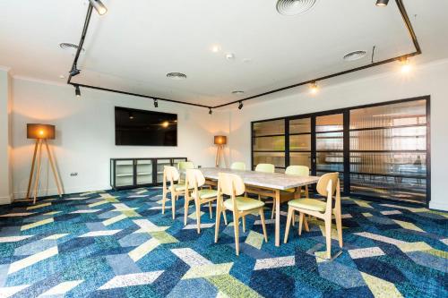 a conference room with a table and chairs at Holiday Inn London Sutton by IHG in Sutton