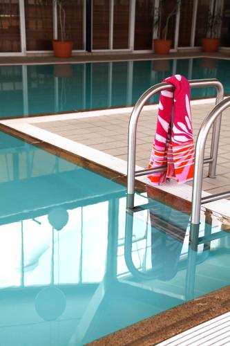 a pair of red socks sitting on a chair next to a swimming pool at Horizons Lake Jindabyne in Jindabyne
