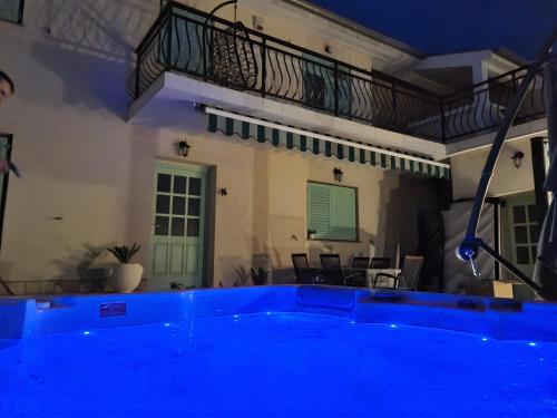 a swimming pool in a house with a blue lighting at Holiday home Marea with jacuzzi in Crikvenica