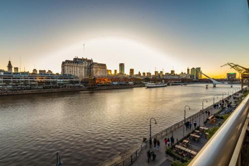 a view of a river with a city in the background at Family Apartment with Puente de la Mujer View in Puerto Madero in Buenos Aires