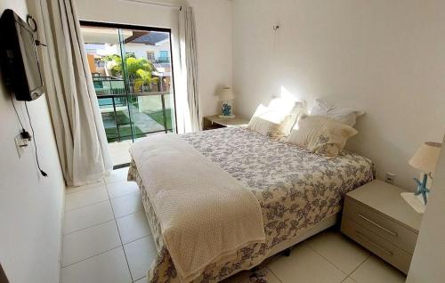 a bedroom with a bed with a window and a television at Atalaia Villagio Della Fontana in Salinópolis
