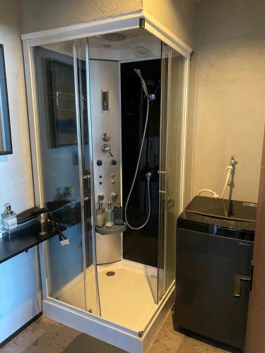 a shower with a glass door in a bathroom at tiny resort misawa - Vacation STAY 14682 in Misawa