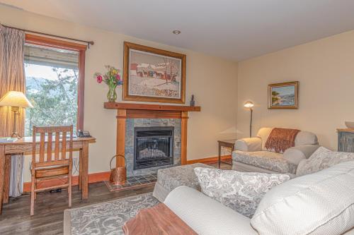 a living room with a fireplace and a couch at Hastings House Country House Hotel in Ganges