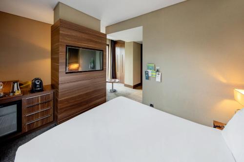 a hotel room with a bed and a flat screen tv at Holiday Inn Istanbul - Kadikoy by IHG in Istanbul