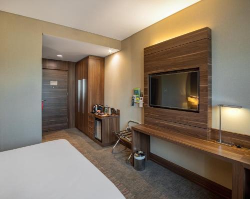 a hotel room with a bed and a flat screen tv at Holiday Inn Istanbul - Kadikoy by IHG in Istanbul