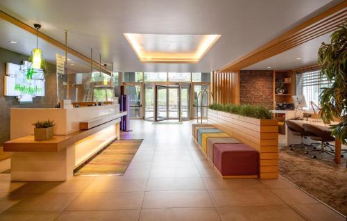 an office lobby with a bench and a table at Holiday Inn Istanbul - Kadikoy by IHG in Istanbul