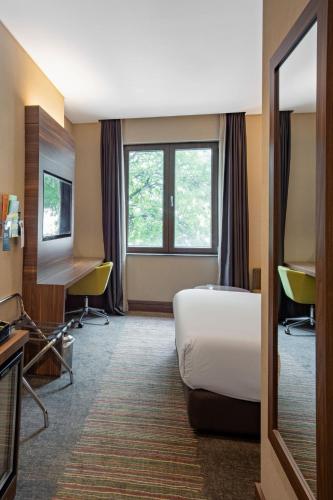 a hotel room with a bed and a television at Holiday Inn Istanbul - Kadikoy by IHG in Istanbul