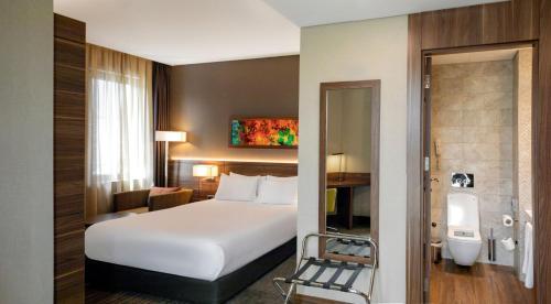 a hotel room with a large bed and a bathroom at Holiday Inn Istanbul - Kadikoy by IHG in Istanbul