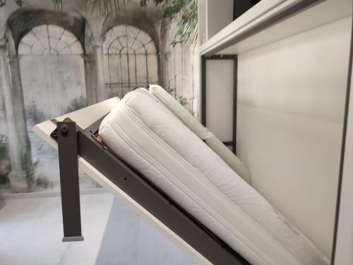 a towel rack with white towels on it at AL PONTE design apartment in Conegliano