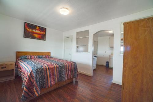 a bedroom with a bed with a colorfulspread on it at Budget Inn By OYO Corpus Christi Beach in Corpus Christi