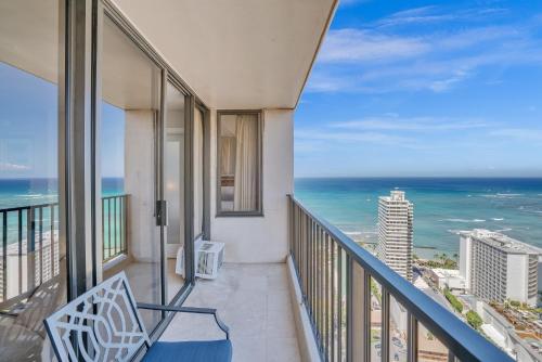 a balcony with a view of the ocean at Beach Oasis with Ocean & City Views with FREE Parking! in Honolulu