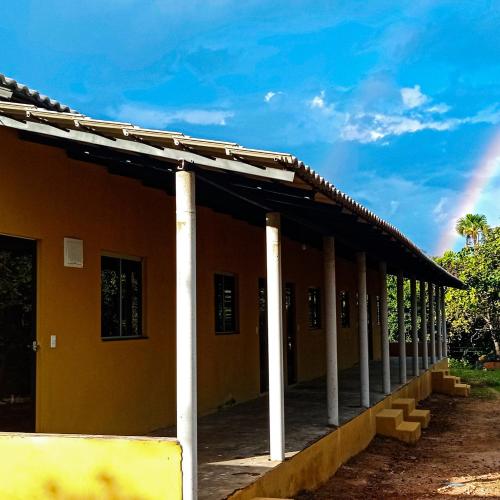 a building with white columns on the side of it at Pousada Diadorim in Sao Domingos de Goias