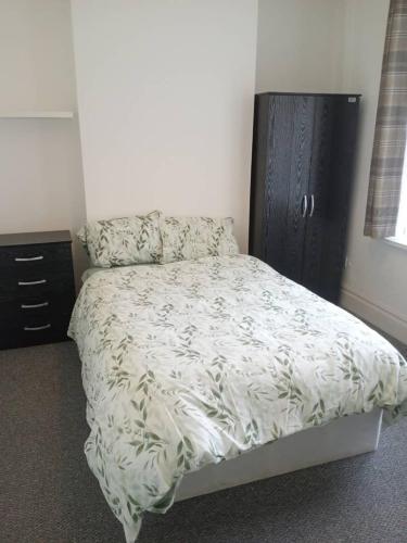 a bedroom with a bed and a black cabinet at Double bed (R1) close to Burnley city centre in Burnley