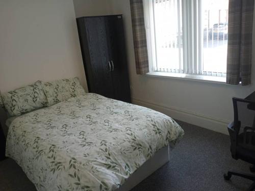 a bedroom with a bed and two windows at Double bed (R1) close to Burnley city centre in Burnley