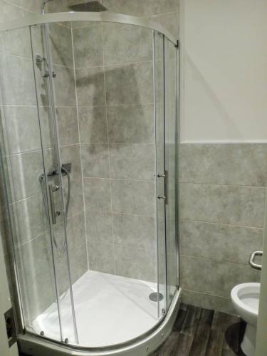 a shower stall in a bathroom with a toilet at Double bed (R1) close to Burnley city centre in Burnley