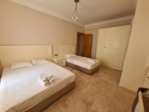 a bedroom with two beds with towels on them at Alanya gold city villa in Alanya