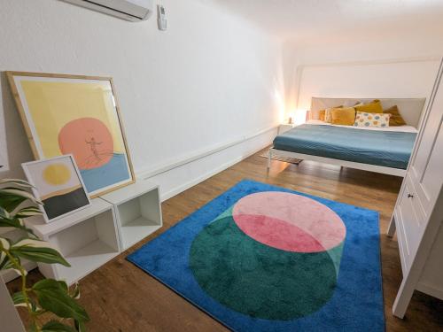 a bedroom with a bed and a blue rug at Stylish 2-Bedroom Apartment in Central Budapest in Budapest