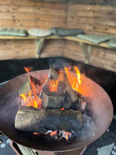 a fire pit with meat and flames in it at The Stable Springmount Accommodation in Dromara