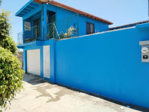 a blue house with a white garage at Monchita's Ensenada Baja, apartments for rent. in Ensenada