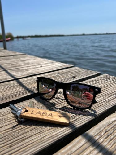 a pair of sunglasses sitting on a wooden dock at LABA Wieleń in Wielen Zaobrzanski