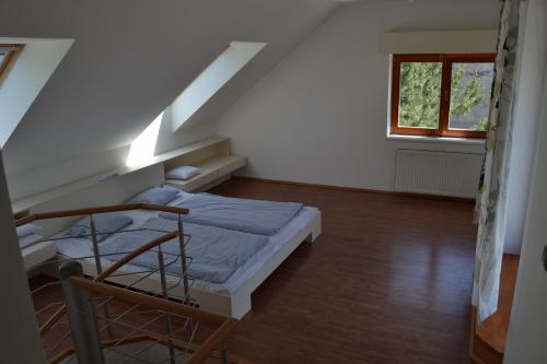 a small room with a bed and a window at Large house with parking, 30 min to Prague center in Úvaly
