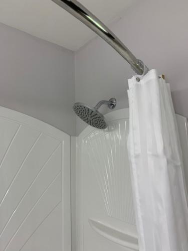 a shower curtain in a bathroom with a shower at Shores Inn & Hotel in Shediac