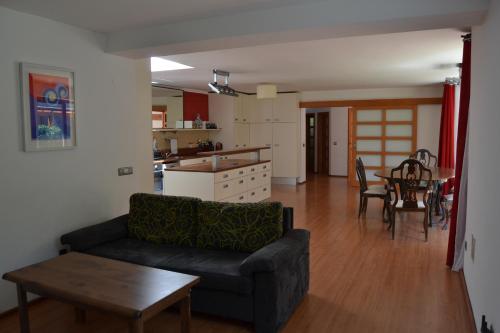 een woonkamer met een bank en een tafel bij Large house with parking, 30 min to Prague center in Úvaly