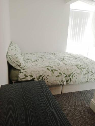 an unmade bed in a bedroom with a window at Double bed (R2) close to Burnley city centre in Burnley