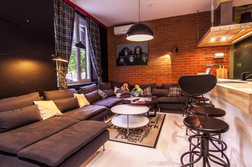 a living room with a couch and a child sitting on a table at KoikaGO Hostel in Kaliningrad