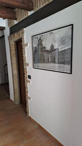 a picture on a wall with a painting on it at Dodo's House in Ferrara