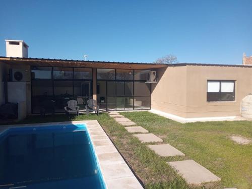 a house with a swimming pool in the yard at CASA TIPO CHALET SALTA in Salta