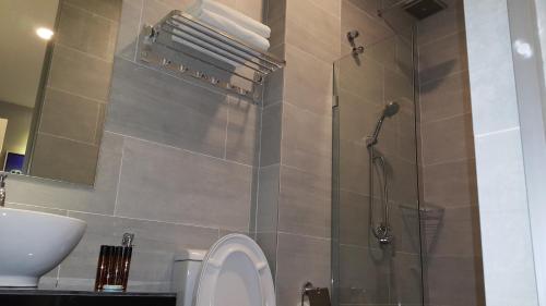 a bathroom with a shower and a toilet and a sink at M Design Hotel @ Shamelin Perkasa in Kuala Lumpur
