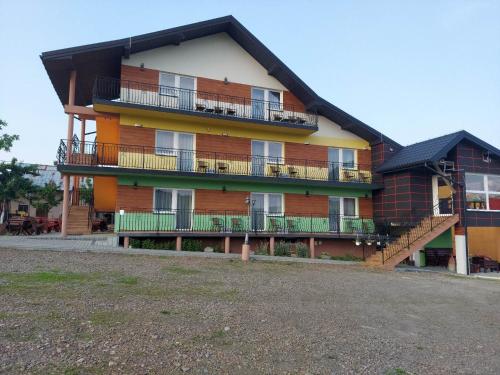 a large building with balconies on the side of it at Apartament i pokoje u Roberta in Polańczyk