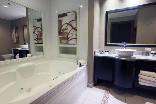 a bathroom with a large tub and a sink at Golden Nugget Biloxi in Biloxi