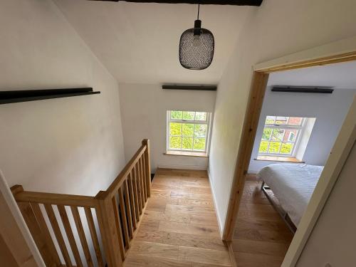 a bedroom with a staircase and a bed and a window at Newtown Townhouse in Newtown
