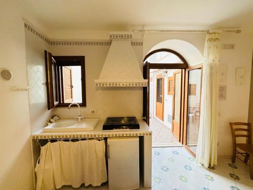 a kitchen with a sink and a stove at La Donzella - Immobilevante in Ponza