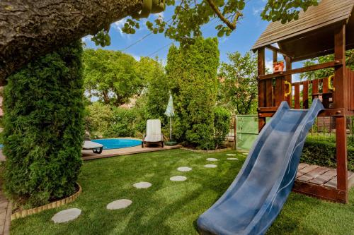 a slide in the yard of a house at LiliHome in Gárdony