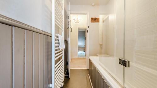 a bathroom with a bath tub and a sink at Rose Cottage in Youlgreave