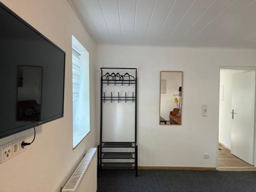 a living room with a tv and a mirror at Zur Guten Stube - Self Check In- 