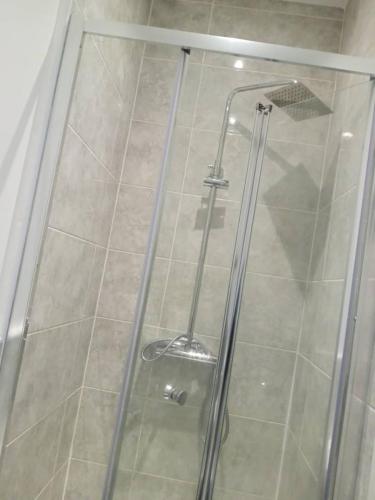 a shower with a glass door in a bathroom at Ensuite double-bed (R4) close to Burnley city centre in Burnley