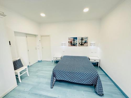 a bedroom with a bed in a white room at Sky Ponza - Immobilevante in Ponza