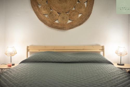 a bedroom with a bed and a mirror on the wall at Casa das Hortas in Vila Franca do Campo
